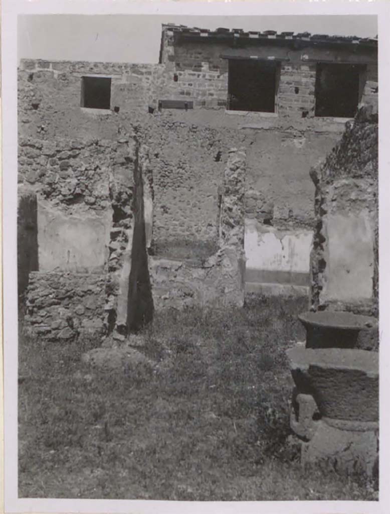 IX.3.12 Pompeii. Pre-1943. Looking north to steps to raised garden area.
According to Warscher, the smallest window would have been from the ala of IX.3.5, the two larger ones next to each other would have been in the south wall of the triclinium in IX.3.5. 
It would seem that the windows have been reconstructed. 
(La fotografia era presa dal pistrino IX.3.10/12. 
La finestra pi� piccola a sinistra era quella dell�ala di IX.3.5, due pi� grandi � l�una accanto all�altra sono quelli del triclinio (nella parete sud di quest�ultimo).
Sembra che le finestre siano state ricostruite regolarmente.)
See Warscher, T. 1942. Catalogo illustrato degli affreschi del Museo Nazionale di Napoli. Sala LXXXII. Vol.4. Rome, Swedish Institute.
