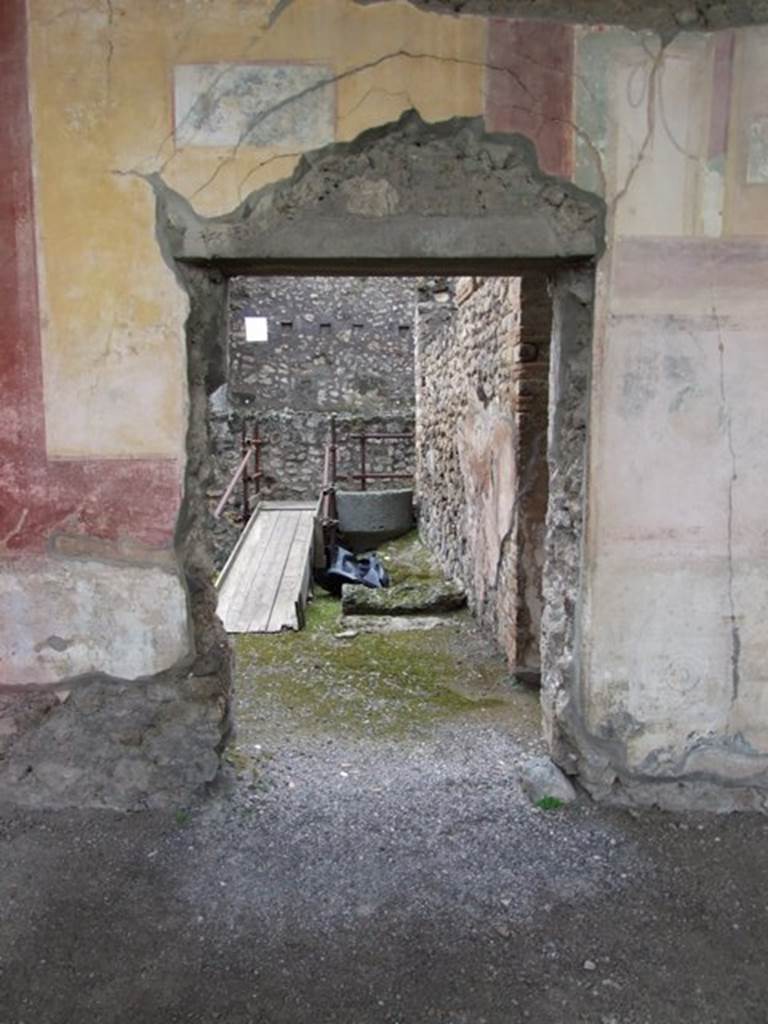 IX.8.6 Pompeii. March 2009. West portico, south door in west wall leading to room 22.
Against the north wall in room 22, are the remains of the lower stone step of the stairs to the upper floor, and an overturned lava stone.
