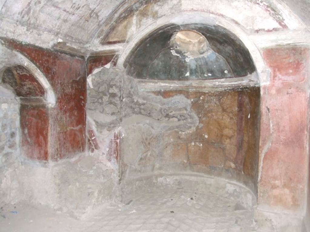 IX.8.6 Pompeii. March 2009. Room 34, west wall of caldarium. In the floor of the arched schola labra, the only two remaining diamond-shaped slabs of marble can be seen. The rest of the floor having been carried away by ancient explorers.
