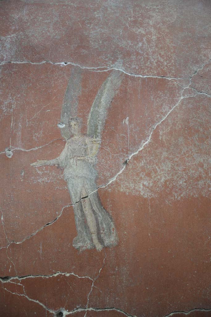 IX.12.6 Pompeii. February 2017.
Room “m”, detail of flying figure on east side of central painting on north wall.
Photo courtesy of Johannes Eber.
.