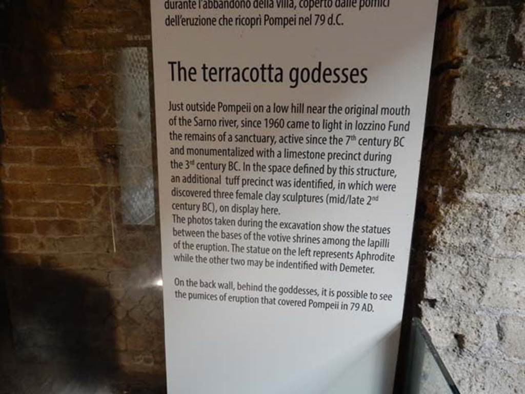 Santuario extraurbano del Fondo Iozzino. May 2018. Information card in the Antiquarium exhibition.
According to this, it was a place of worship as early as the 7th century BC and was monumentalized with a limestone precinct in the 3rd century BC.
In the space defined by this structure, an additional tufa precinct was identified, in which were discovered three female clay sculptures dating to the mid to late 2nd century BC.
Photo courtesy of Buzz Ferebee.