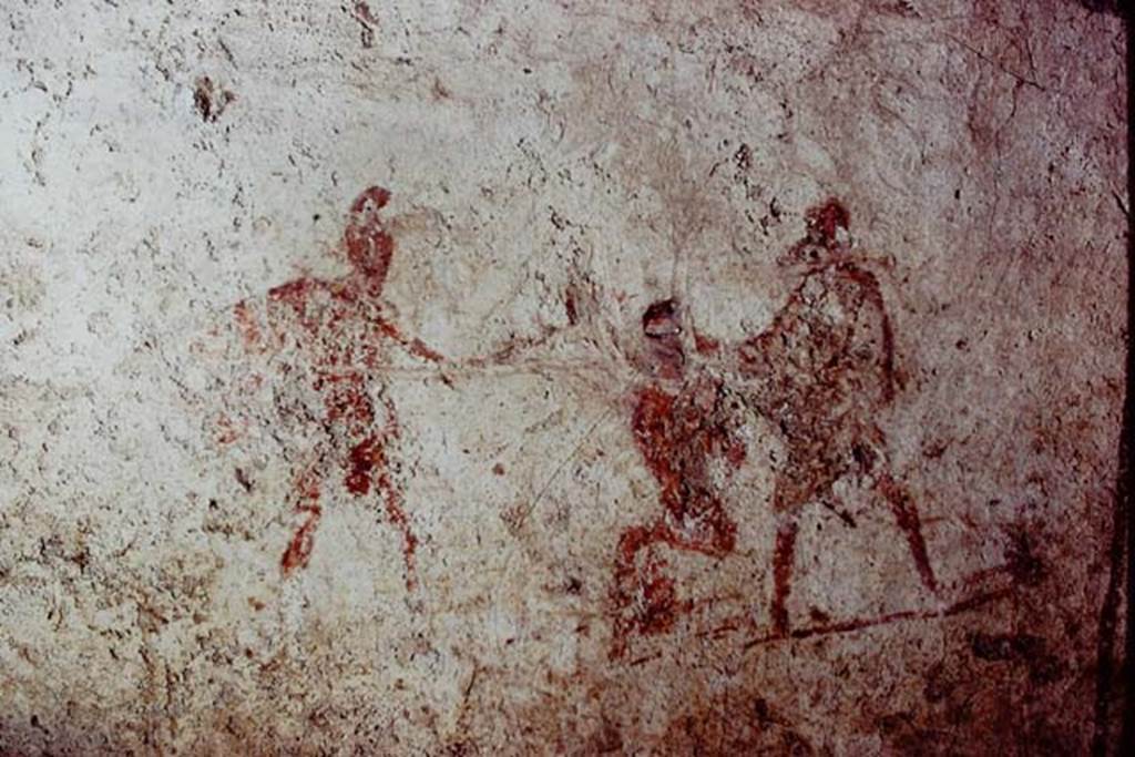 Santa Maria Capua Vetere, Mithraeum. 1974. Initiation painting located on front of benches.
Photo by Stanley A. Jashemski.
Source: The Wilhelmina and Stanley A. Jashemski archive in the University of Maryland Library, Special Collections (See collection page) and made available under the Creative Commons Attribution-Non Commercial License v.4. See Licence and use details.
J74f0583
According to Minto, the initiate is shown seated, with hands tied behind his back and his eyes bandaged. On the right, dressed in a white tunic, is the mystagogus, the teacher who has prepared the initiate for entry to the cult. On the left is a priest in an oriental costume and wearing a Phrygian cap and carries a sword in his hand.
See Notizie degli Scavi di Antichità, 1924 p. 369, fig. 11.