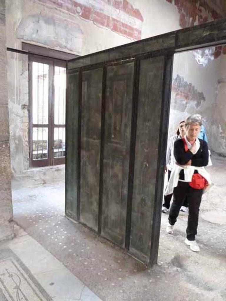 III.11 Herculaneum. May 2010. Wooden Screen at north end, taken from tablinum.