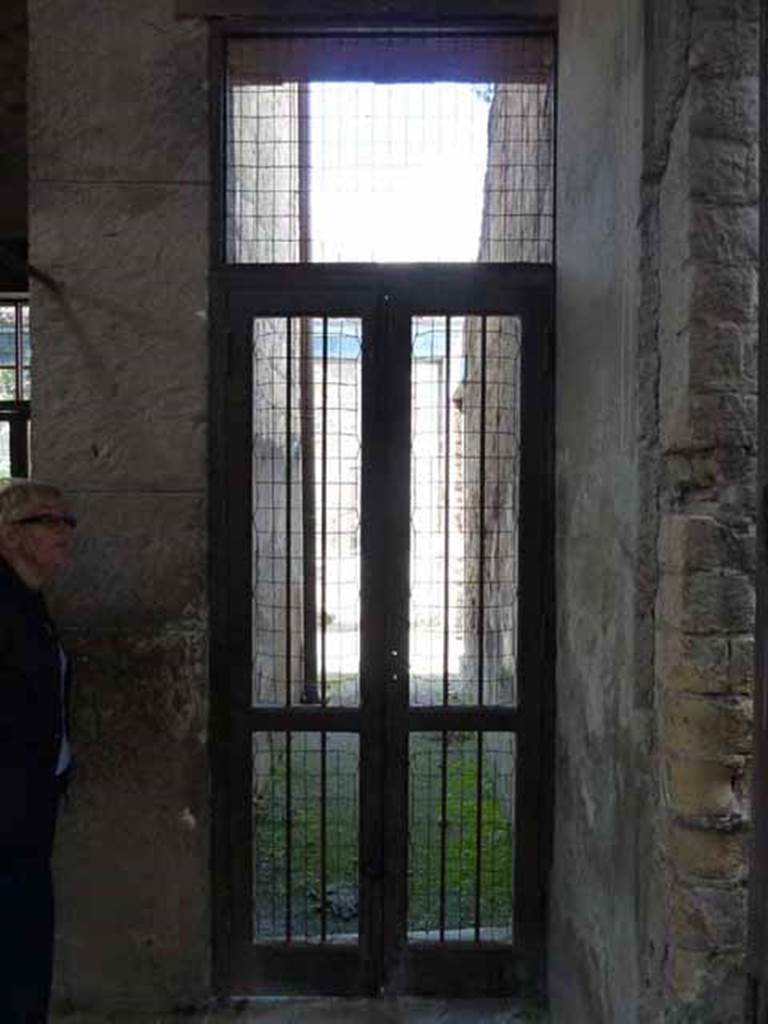 III.11 Herculaneum. May 2010. Doorway to corridor 10, looking west to peristyle from atrium.