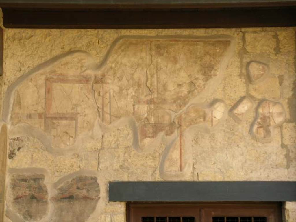 III.11 Herculaneum. May 2005. Detail on south wall above doorway from room 8. Photo courtesy of Nicolas Monteix. 
