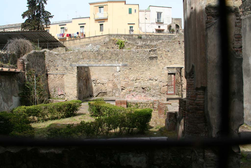 III.11 Herculaneum. April 2013. 
Looking west across peristyle garden from tablinum, towards doorways to rooms 15, 16, 17. Photo courtesy of Klaus Heese.

