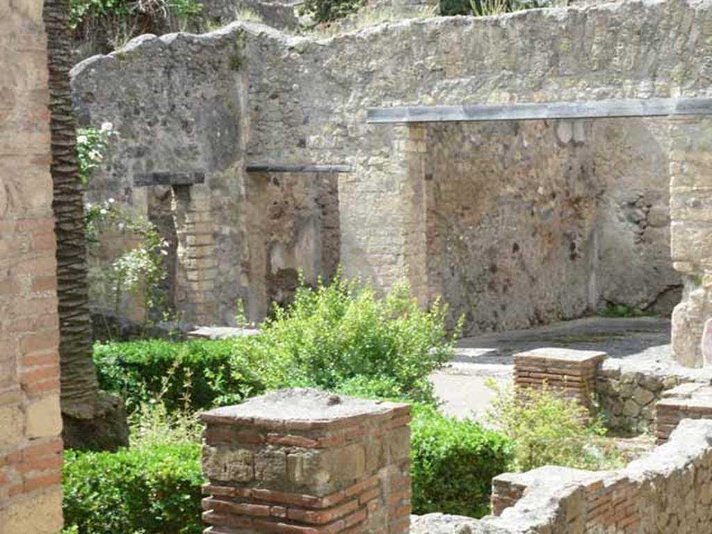 III.11 Herculaneum. May 2010. Looking south-west across garden peristyle towards doorways to rooms 14 and 15, on left and large triclinium 16, on right. 