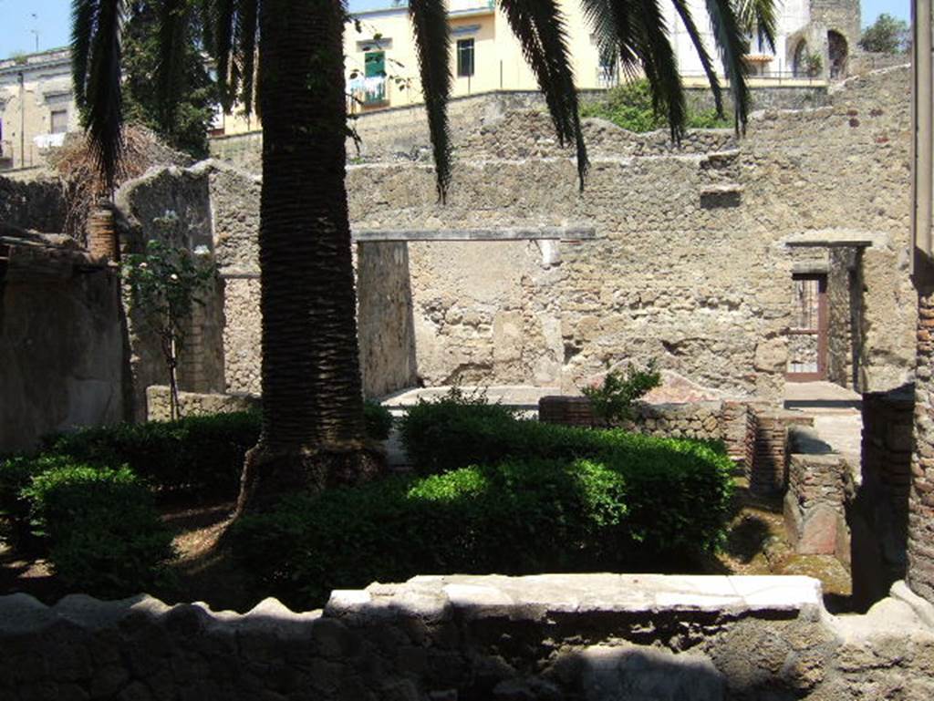 III.11 Herculaneum. May 2006. Looking west across the garden area. According to Maiuri, the central room on the west side served as the triclinium. It was brought to light in the old excavations and the decoration is much deteriorated, as in the other rooms surrounding it.
See Maiuri, Amedeo, (1977). Herculaneum. 7th English ed, of Guide books to the Museums Galleries and Monuments of Italy, No.53 (p.33).
