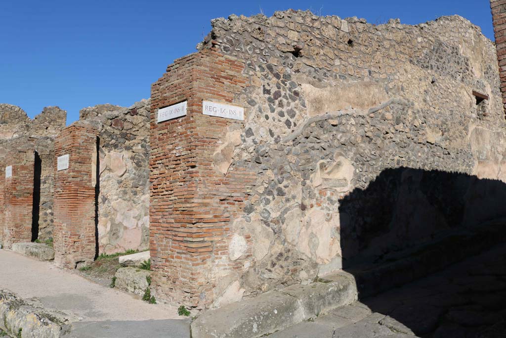 IX.2.11 and IX.2.12 Pompeii, on left. December 2018. 
Looking north at junction of Via Stabiana, on left, and Vicolo di Balbo, on right. 
The street shrine at IX.2.12, can be seen on north wall of Vicolo di Balbo, centre right. Photo courtesy of Aude Durand.
