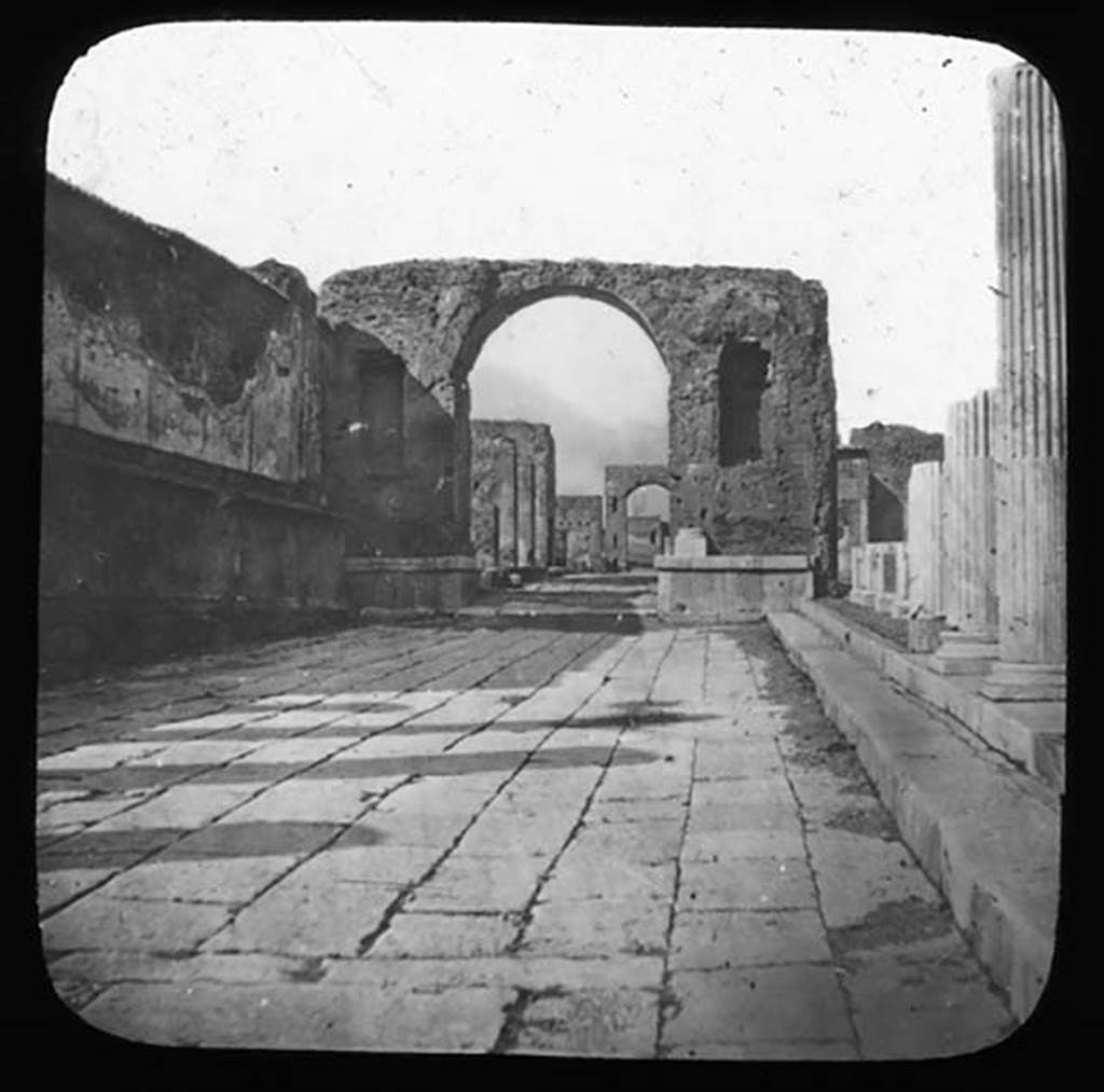 Arch at north-east end of the Forum. Photo by Harris Manchester College Oxford.
Looking north along the east side of the Forum to the arch. Used with the permission of the Institute of Archaeology, University of Oxford. File name HMCbx3im043a. Source ID. 41381.  
