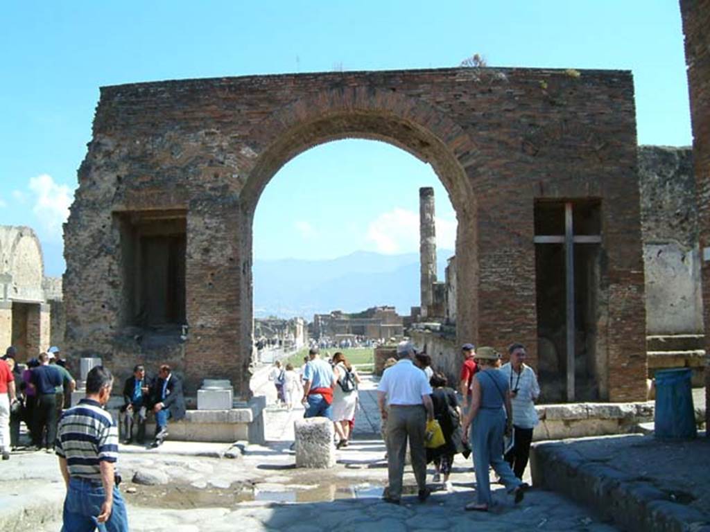Arch at north-east end of the Forum. May 2002. North side with fountains. 
Looking south through arch from Via del Foro. Photo courtesy of David Hingston.
