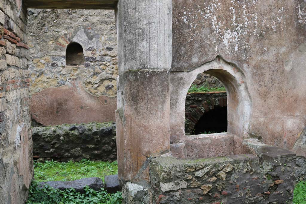 VIII.4.4 Pompeii. December 2018. 
Looking east to doorway to room 7, with square basin beneath arched opening, on the south side. Photo courtesy of Aude Durand.
According to Boyce –
In the kitchen opening off the east side of the peristyle, in the east wall above a masonry tub, is a small arched niche (h.0.47, w.0.36, d.0.27, h. above floor 1.60) adorned with an aedicula façade.
See Boyce G. K., 1937. Corpus of the Lararia of Pompeii. Rome: MAAR 14. (p. 76, no.358).
See Giacobello, F., 2008. Larari Pompeiani: Iconografia e culto dei Lari in ambito domestico. Milano: LED Edizioni, (p.199, no.89)



