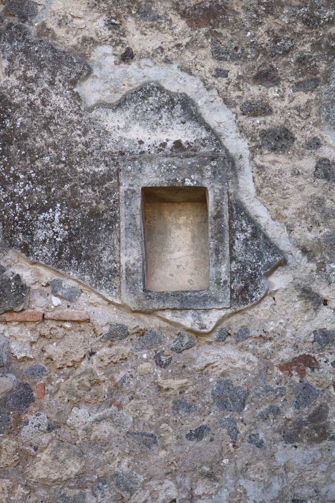 VIII.4.5 Pompeii. December 2018. South wall with niche. Photo courtesy of Aude Durand.
According to Boyce –
In the south wall is a small rectangular niche (h.0.37, w.0.23, d.0.18, h. above floor 2.0) adorned with an aedicula façade.
See Boyce G. K., 1937. Corpus of the Lararia of Pompeii. Rome: MAAR 14. (p.76, no. 359). 

