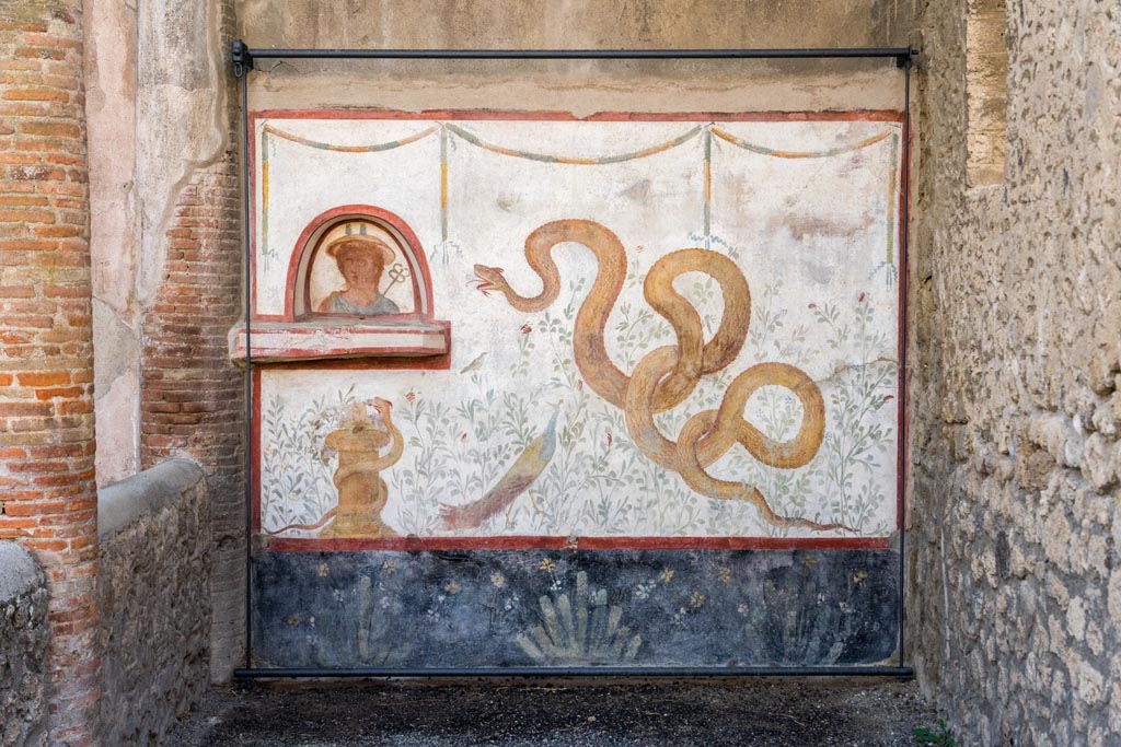 I.6.2 Pompeii. October 2023. Painted lararium on west wall near portico. Photo courtesy of Johannes Eber.
See Boyce G. K., 1937. Corpus of the Lararia of Pompeii. Rome: MAAR 14. (p.25, no.36). 
See Giacobello, F., 2008. Larari Pompeiani: Iconografia e culto dei Lari in ambito domestico. Milano: LED Edizioni, (p.253, no.V5)

