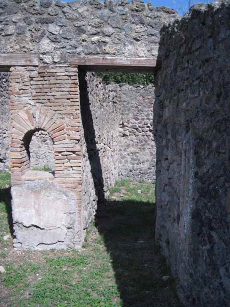 I.1.2 Pompeii. September 2010. Doorway to large room on south side of customers room. Photo courtesy of Drew Baker. According to Fiorelli this contained the hearth, the latrine and a staircase to the upper floor.

