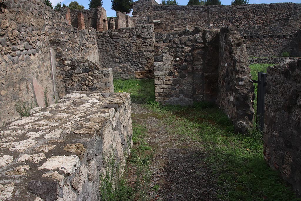 I.1.9 Pompeii. October 2024. Looking east across bar-room towards doorway to rear room. Photo courtesy of Klaus Heese.