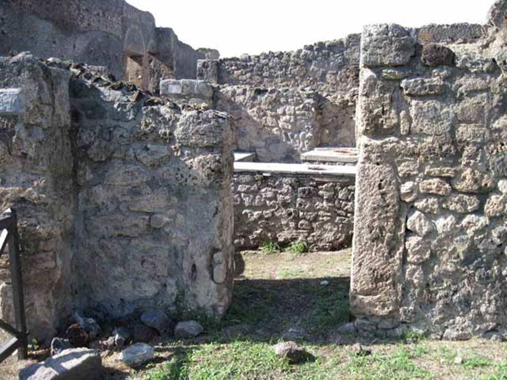 I.2.7 Pompeii. September 2010. North wall in north-west corner of shop, with doorway into I.2.8..Photo courtesy of Drew Baker.