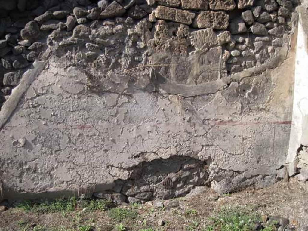 I.2.7 Pompeii. September 2010. North wall of rear room, with site of stairs on left. The wall (zoccolo and middle area) would have been painted white, panelled and compartmentalised by red painted lines (see corner area of north wall, on right). 
Photo courtesy of Drew Baker.
