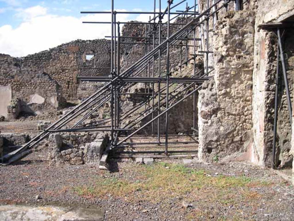 I.2.10 Pompeii. September 2010. Remains of north wall of atrium (north-east side), with doorway to rear of house, on right. Looking north towards I.2.11/12/13/14. Photo courtesy of Drew Baker.
