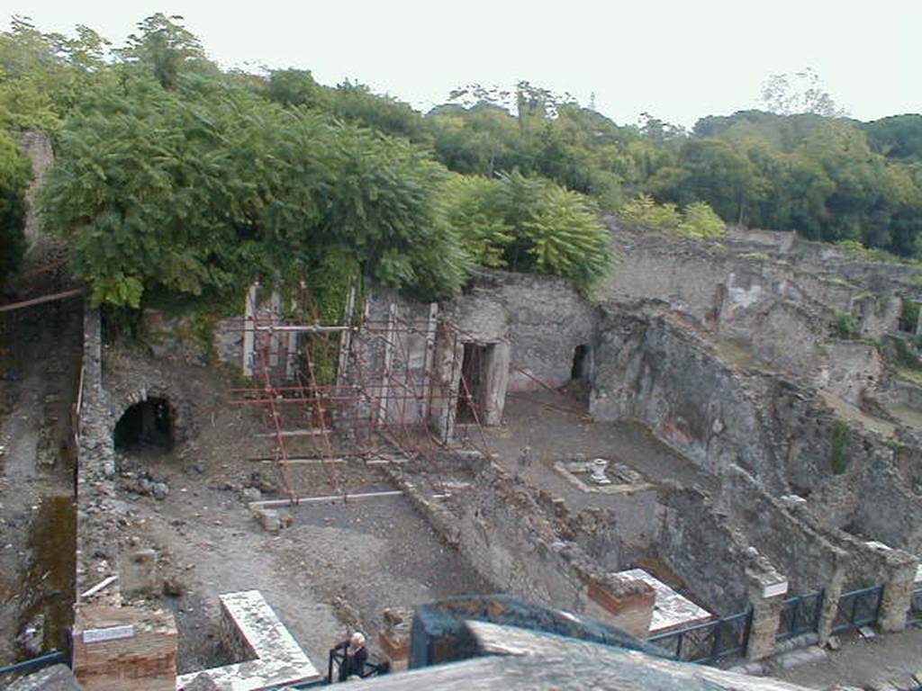 I.2.10 Pompeii. September 2004. The triclinium is in centre of picture behind right-hand end of scaffolding, at the side of the doorway to the corridor to the rear.
