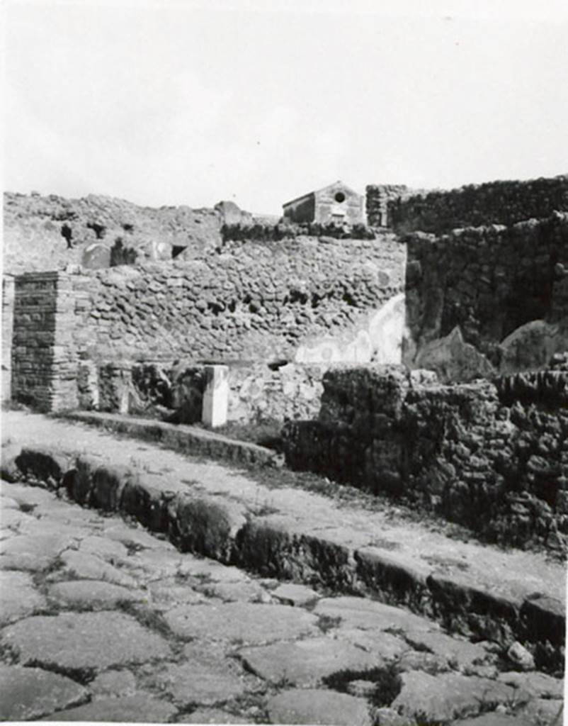 I.3.11 Pompeii. 1935 photograph taken by Tatiana Warscher. Looking north-east towards entrance from Via Stabiana. 
See Warscher, T, 1935: Codex Topographicus Pompejanus, Regio I, 3: (no.28), Rome, DAIR, whose copyright it remains.  
According to Warcher, quoting Fiorelli, “There was a masonry podium on the inside left of the entrance of this shop, containing eight terracotta urns, annexed at the side was a room used by the customers.”
