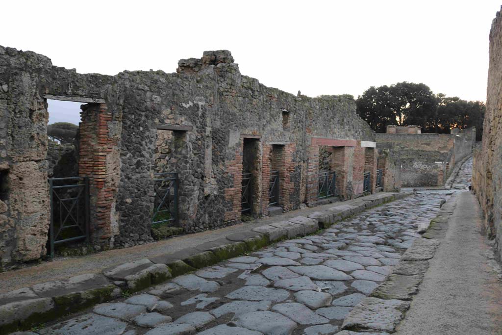 I.3.19, Pompeii, on left. December 2018. Looking west towards doorways on south side (I.3) of Vicolo del Menandro. Photo courtesy of Aude Durand.