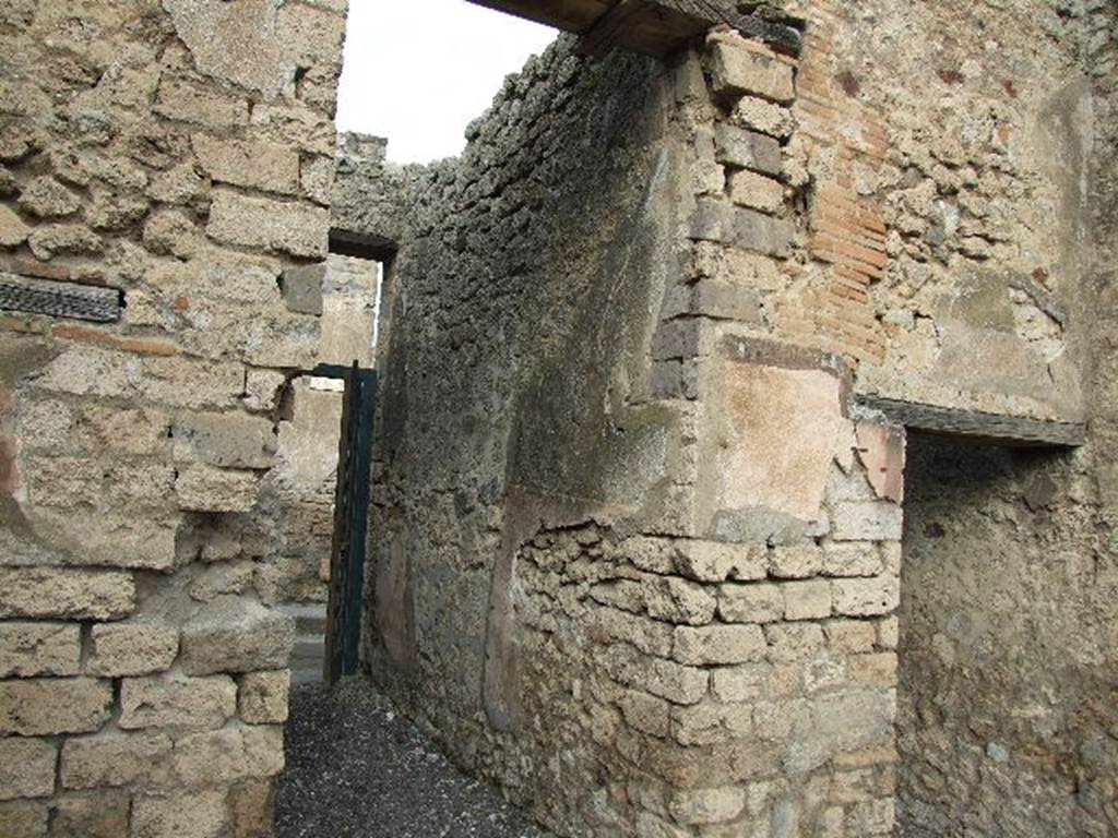 I.3.24 Pompeii. December 2006. Entrance corridor, on left, and doorway to room on east side of fauces, or entrance corridor, on right.