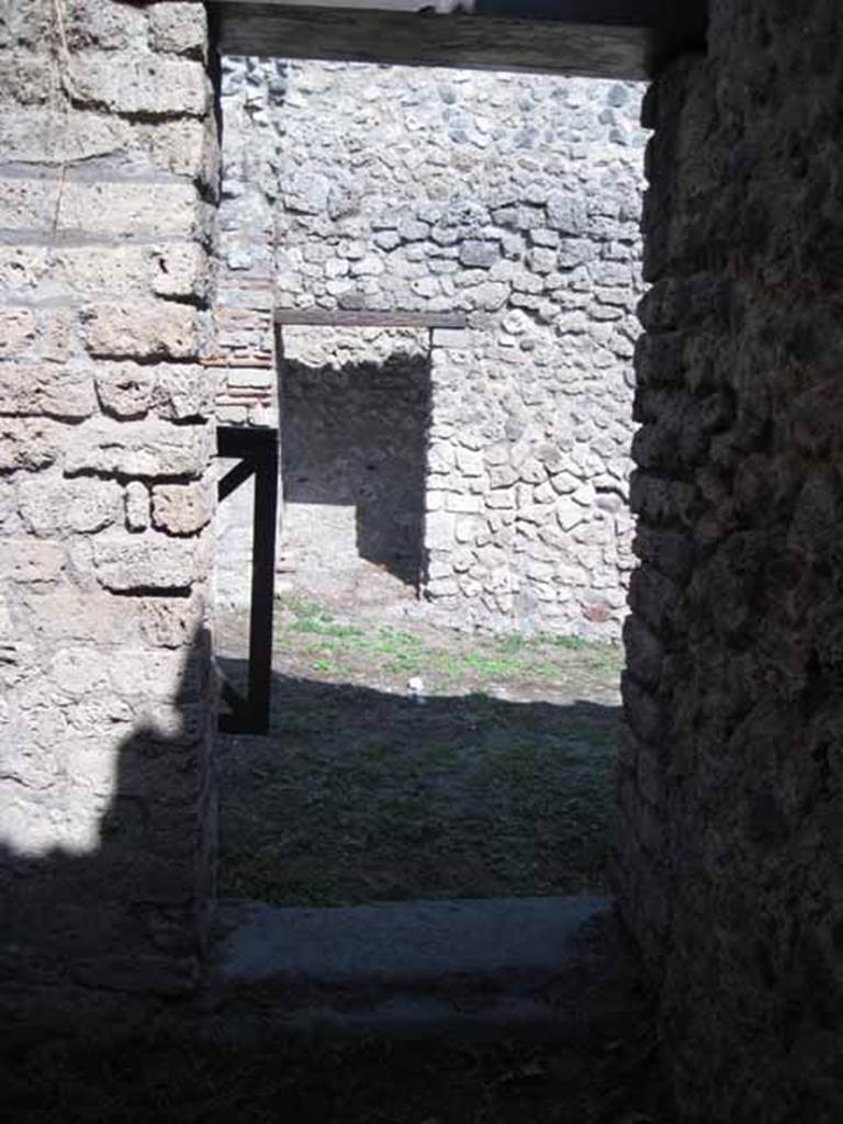 I.5.2 Pompeii. September 2010. Doorway looking east towards shop-room, from room on west side of it. Photo courtesy of Drew Baker.
