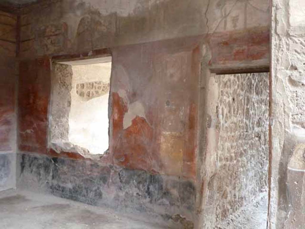 I.6.7 Pompeii. May 2010. South wall of large oecus, with window to triclinium, and corridor to rear.