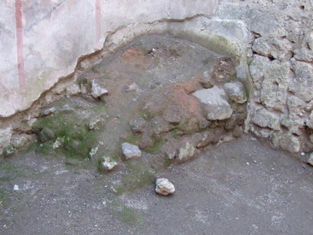 I.6.10 Pompeii. December 2007. Remains of masonry base of staircase in south-west corner of front room.