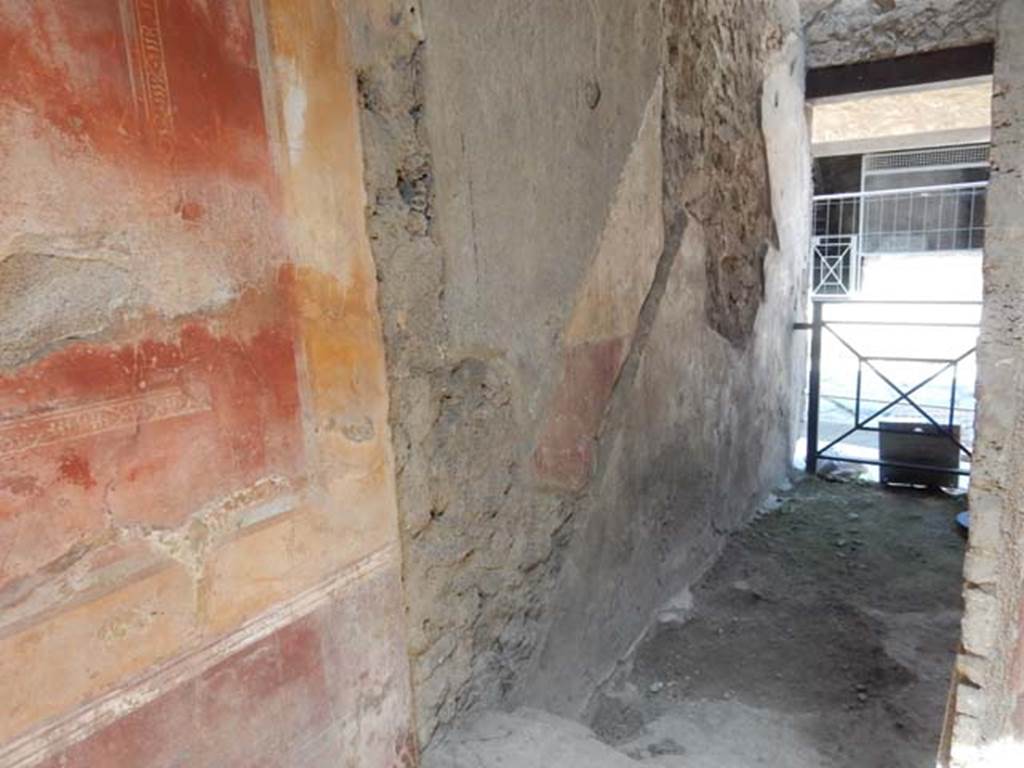 I.7.2/3 Pompeii. May 2016. Looking towards west wall through doorway  in north-west corner of atrium of I.7.3, leading north to entrance at I.7.2, steps to upper floor. 
Photo courtesy of Buzz Ferebee.
