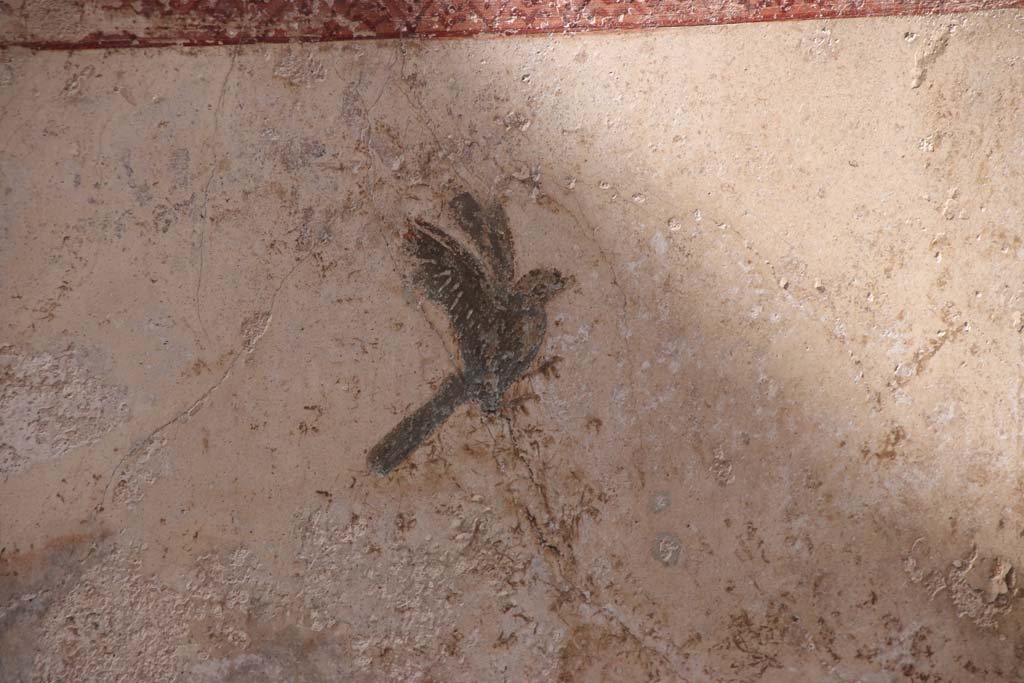 I.7.11 Pompeii. September 2021. Painted bird in centre of lower west panel on north wall. Photo courtesy of Klaus Heese.