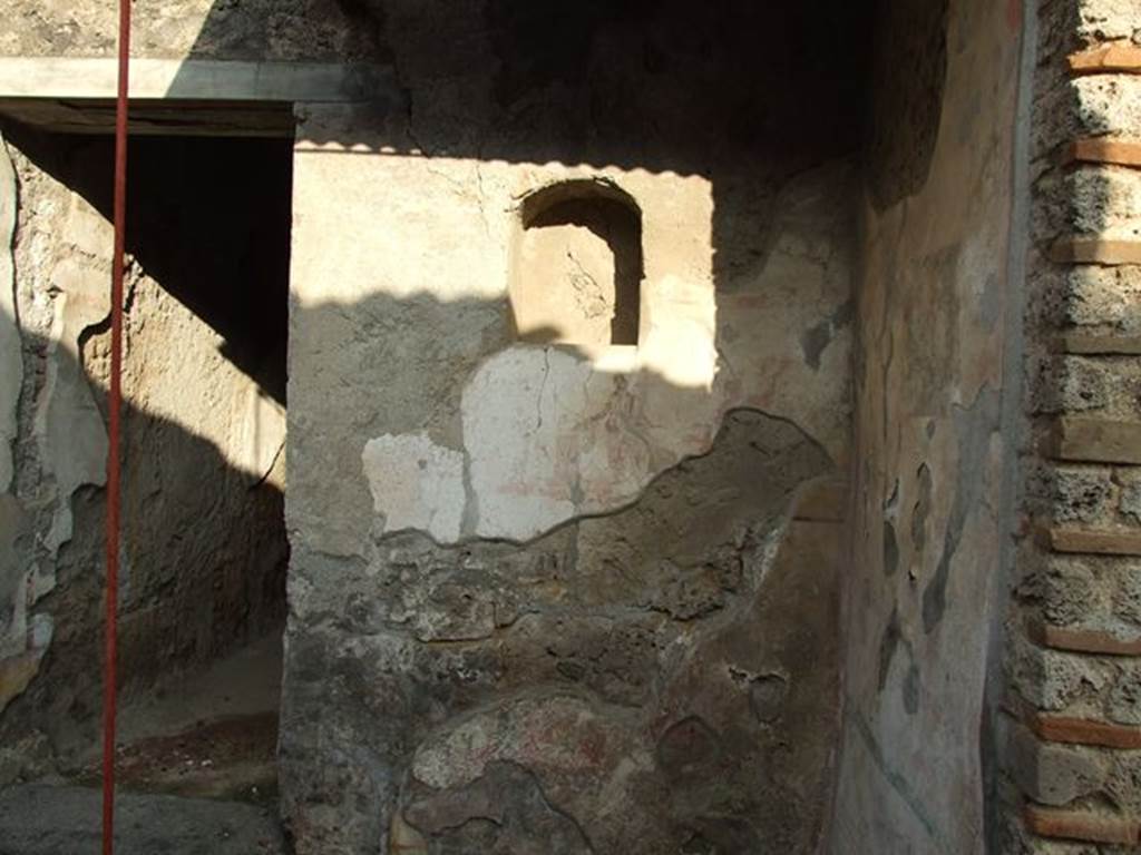 I.7.11 Casa dell’ Efebo or Domus P. Cornelius Tages.  Remains of Lararium on east side of atrium belonging to original house I.7.10.  See Fröhlich, T., 1991, Lararien und Fassadenbilder in den Vesuvstädten.  Mainz: von Zabern.  (L5:p.251, T: 3,1, 24,1)