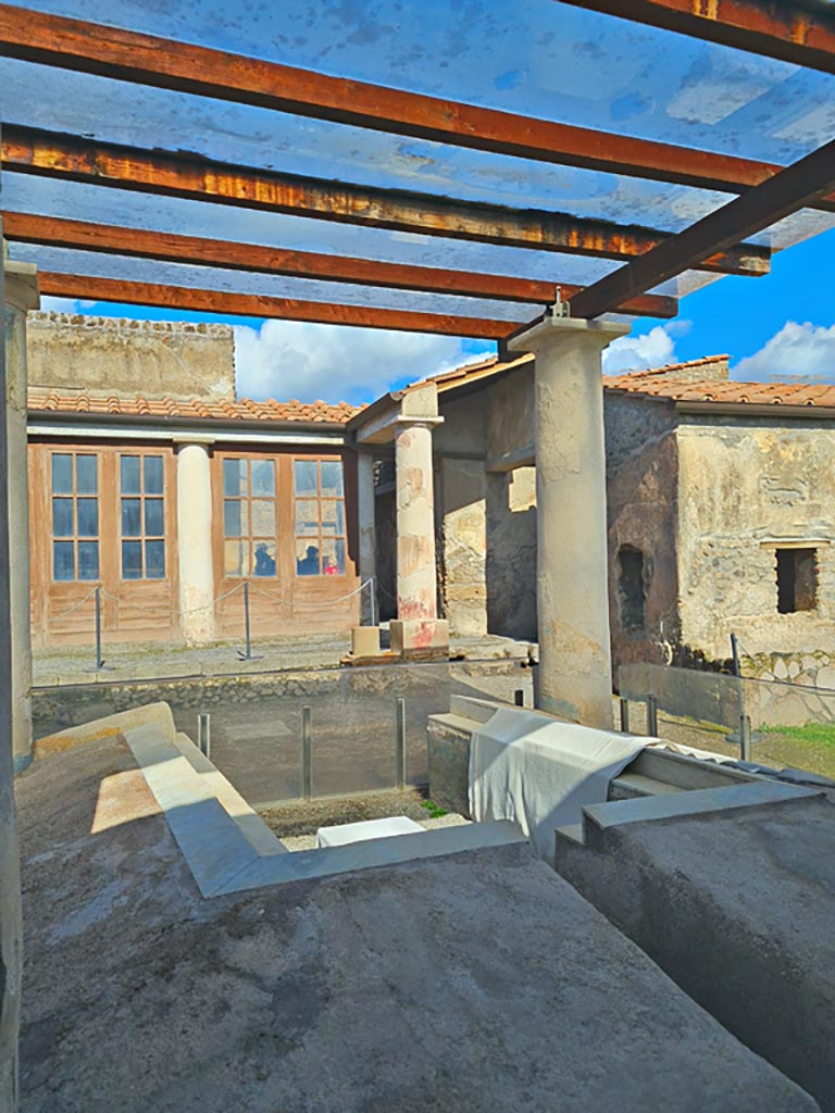 I.7.12 Pompeii. March 2024.
Looking north across triclinium in garden towards north portico and window from cubiculum, on right. 
Photo courtesy of Giuseppe Ciaramella.
