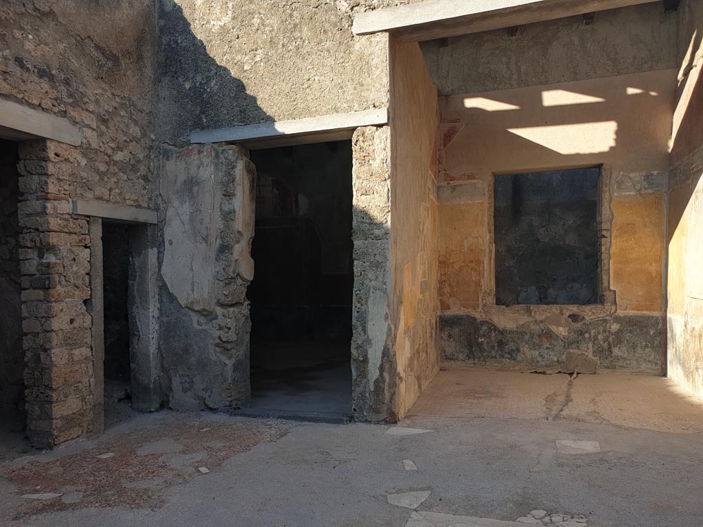 I.7.19 Pompeii. August 2023. North-east corner of atrium, with doorway to triclinium and tablinum. Photo courtesy of Maribel Velasco.