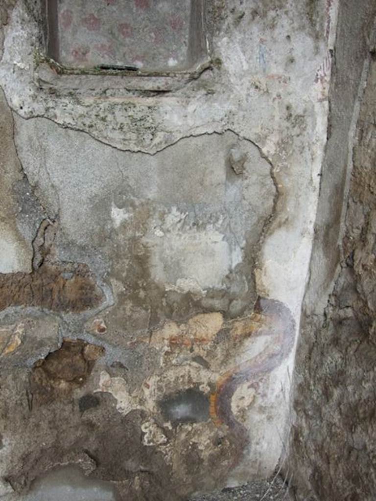 I.8.10 Pompeii. March 2009.  Area on east side of niche, with remains of painting of a Lar.  See Fröhlich, T., 1991. Lararien und Fassadenbilder in den Vesuvstädten. Mainz: von Zabern. (L9: p.253, T25.2).