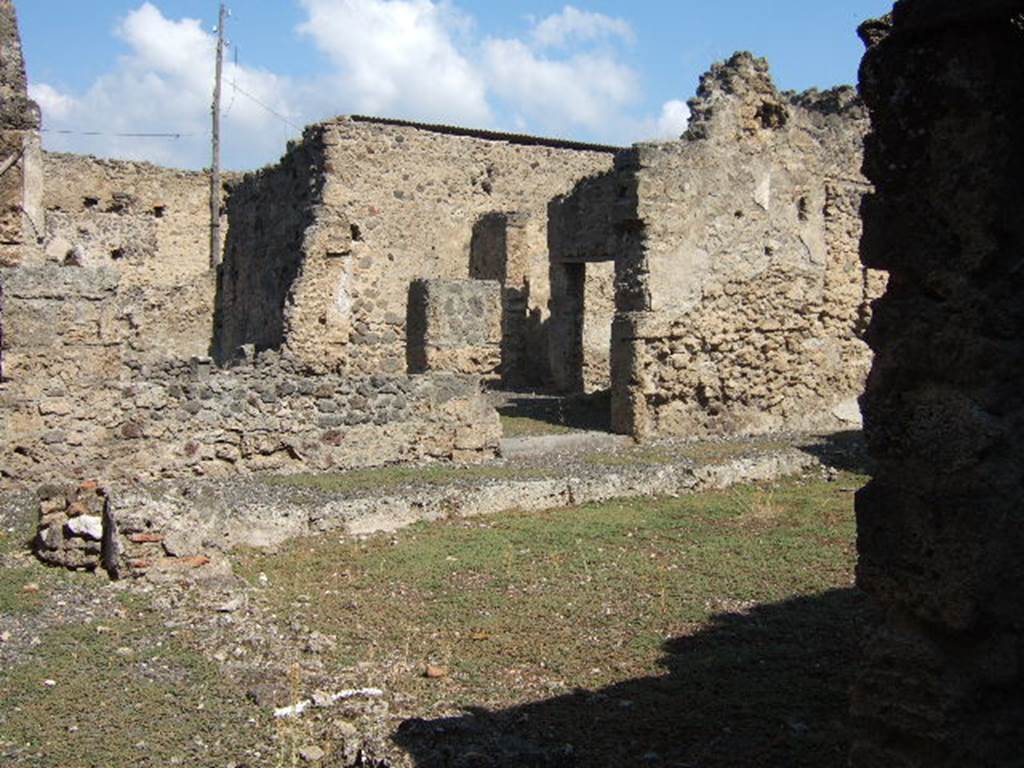 I.8.13 Pompeii. September 2005. Looking north-east from entrance, towards rear of house. According to Della Corte, in a cubiculum on the south-east side of the inner courtyard, interesting graffiti were found –
See Della Corte, M., 1965.  Case ed Abitanti di Pompei. Napoli: Fausto Fiorentino. (p.327) 
Idibus Iulis inaures pos(i)tas ad Faustilla(m).
Pro denariis II deduxit aeris a(ssem).
Ex sum(ma) XXX     [CIL IV 8203]
According to Epigraphik-Datenbank Clauss/Slaby (See www.manfredclauss.de) this read as –
Idibus Iuli(i)s 
inaures postas ad Faustilla(m) 
pro |(denariis) II usura(m) deduxit aeris a(ssem) 
ex sum(ma) XXX                      [CIL IV 8203] 
According to Cooley, this was found to the right of CIL IV 8204, in the south-east corner of the bedroom.
She translated it as –
“15 July.  Earrings deposited with Faustilla. Per two denarii she took as usury one copper as.  From a total? 30.”   [CIL IV 8203]  
See Cooley, A. and M.G.L., 2004. Pompeii : A Sourcebook. London : Routledge. (p.170)
According to another book, it translated as -
“On July fifteenth I pawned earrings to Faustilla for 2 denarii (equivalent to 32 asses). From this amount, she deducted one-thirtieth as interest for the monthly usury of one as”     [CIL IV 8203]  
See Panetta, M. R. (ed). 2004. Pompeii, the history, life and art of the buried city. Italy, White Star Publishers; (p. 231)

IV non(as) Iul(ias) paenulam palliolum [posita ad Fau]stillam Pr[oden.]
L [deduxit ?] XIII semis ( ?).
[Aeri]s a(sses) VIII     [CIL IV 8204]
According to Epigraphik-Datenbank Clauss/Slaby (See www.manfredclauss.de) this read as –
IV Non(as) Iul(ias) 
paenulam palliolum [posita ad Fau]stilla(m) 
pr[o |(denariis)] L usur[a] 
[deduxit] XIII s(emissem) 
[aeri]s a(sses) VIII       [CIL IV 8204]
According to Cooley, this was found in the south-east corner of the bedroom.
She translated it as –
“4 July. Hooded cloak and small cloak (deposited by Fau)stilla. Per 50 (…)usury (…) 14 and a half (…) 8 asses”.   [CIL IV 8204]
See Cooley, A. and M.G.L., 2004. Pompeii : A Sourcebook. London : Routledge. (p.170)
The other book describes it as another graffito found in the same room but written just a few days earlier on July 4th.
This time Faustilla received another bitter pledge, this time a cape with a hood.
See Panetta, M. R. (ed). 2004. Pompeii, the history, life and art of the buried city. Italy, White Star Publishers; (p. 231)

