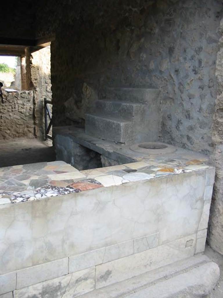 I.9.3 Pompeii. May 2003.  Marble counter, display shelving and entrance sill. Photo courtesy of Nicolas Monteix.

