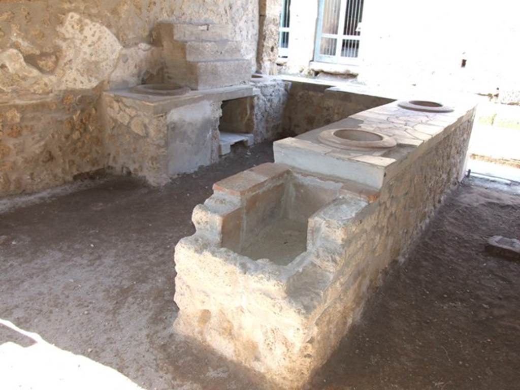 I.9.4 Pompeii.  March 2009.  Rear view of counter with hearth.