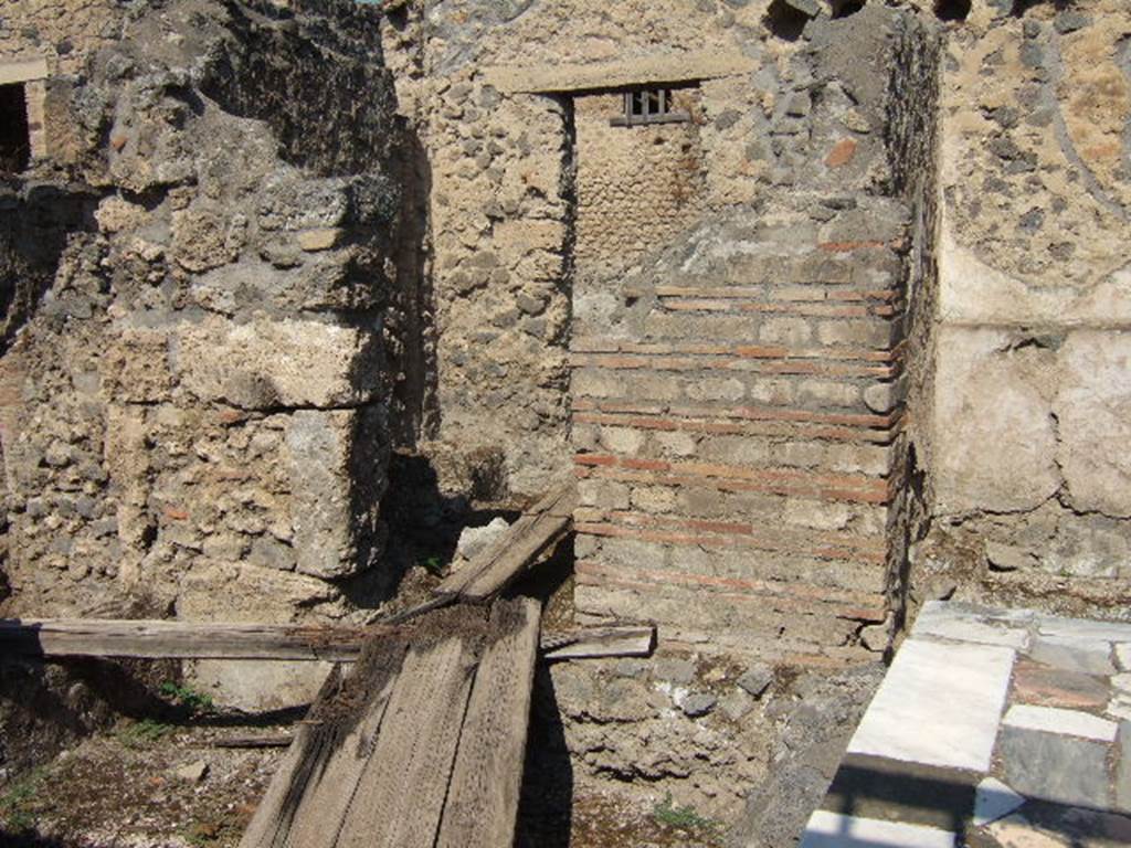 I.9.11 Pompeii.   September 2005.  Rear west room and door to rear yard.