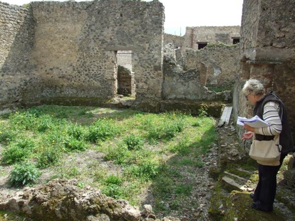 I.9.11 Pompeii.  March 2009.  Looking south across yard area, to rear door into bar 