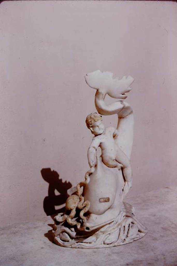 I.9.14 Pompeii. 1966. Marble amorino on dolphin with octopus.  Photo by Stanley A. Jashemski.
Source: The Wilhelmina and Stanley A. Jashemski archive in the University of Maryland Library, Special Collections (See collection page) and made available under the Creative Commons Attribution-Non Commercial License v.4. See Licence and use details.
J66f0740
