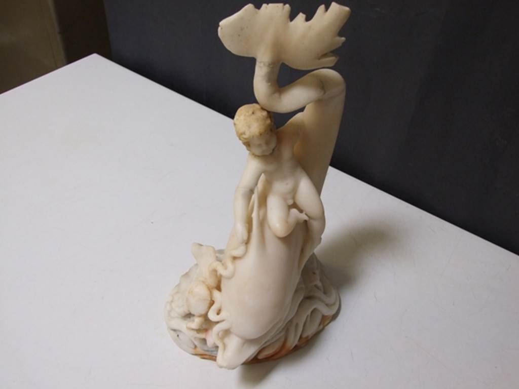 I.9.14 Pompeii.  Marble fountain statuette.  Amorino on dolphin with octopus.  SAP inventory number 8126.  Found in 1951.  