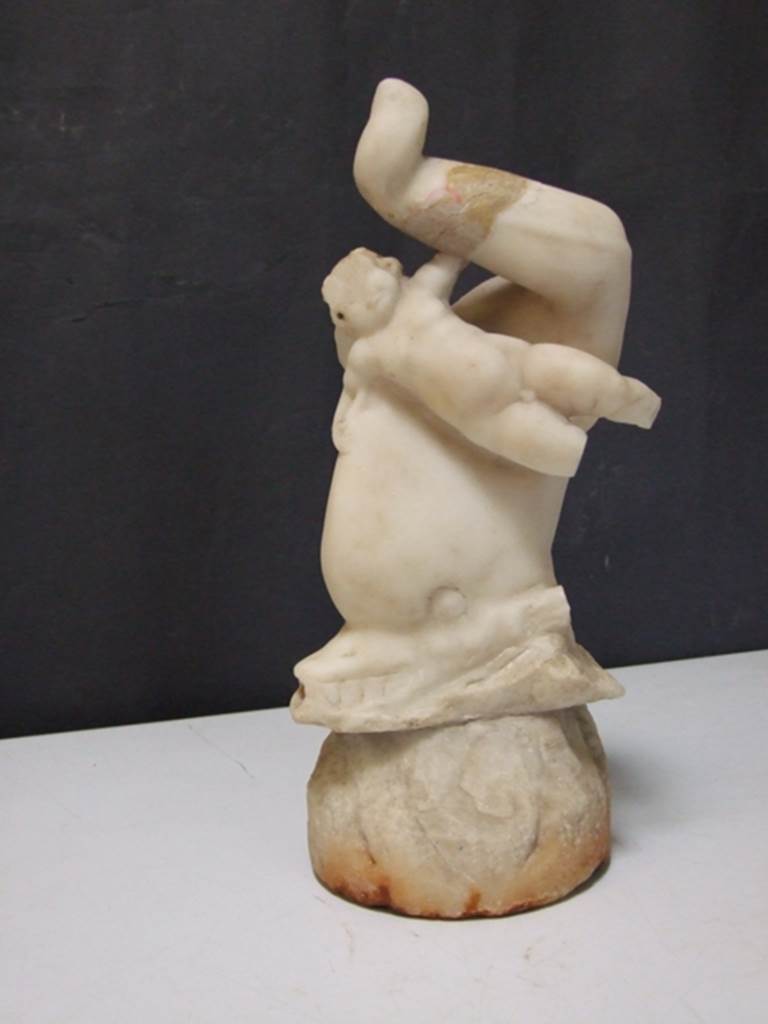 I.9.14 Pompeii.  Marble fountain statuette.  Amorino riding on dolphin.  SAP inventory number 8129.  Found in 1951.