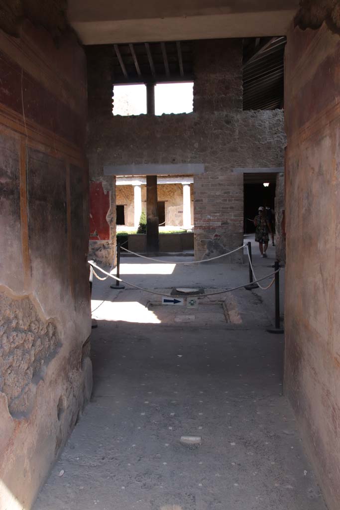 I.10.11 Pompeii. September 2021. 
Room 1, looking east across entrance corridor towards room 2, atrium. Photo courtesy of Klaus Heese.
