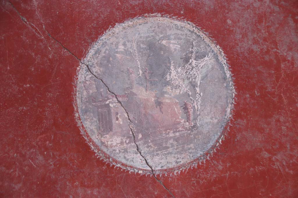 I.10.11 Pompeii. September 2021. 
Room 2, detail of Sacred Landscape on medallion on west (left) end of north wall. Photo courtesy of Klaus Heese.

