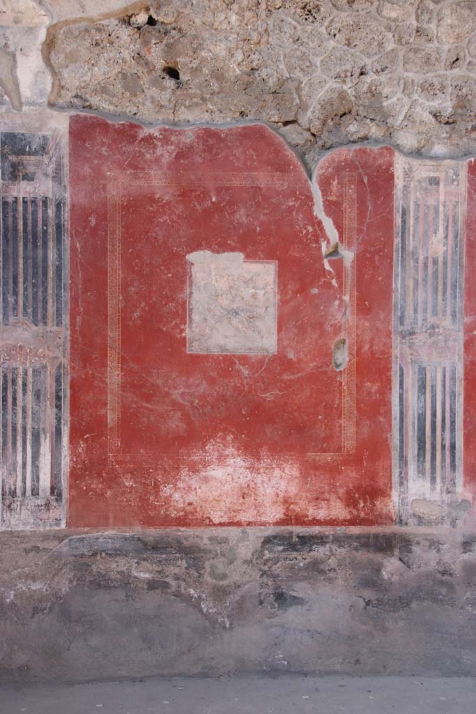 I.10.11 Pompeii. September 2021. 
Room 2, wall painting in central panel on north wall of atrium. Photo courtesy of Klaus Heese.
