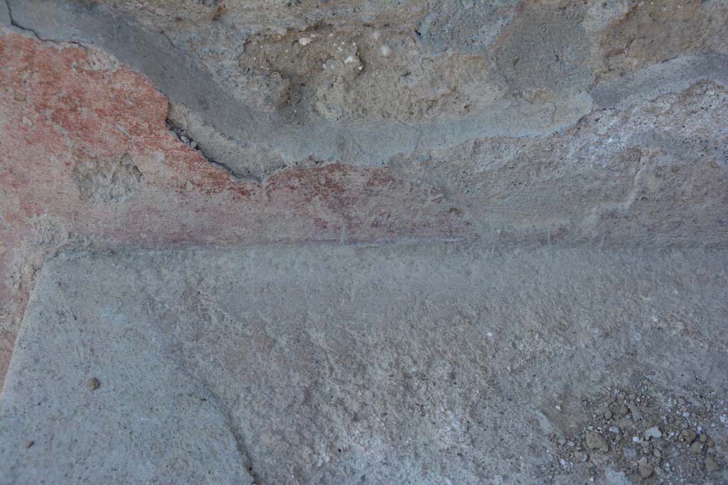 I.10.18 Pompeii. April 2017. Detail of remaining painted plaster at rear of bench seating on south side of entrance doorway. 
Photo courtesy Adrian Hielscher.
