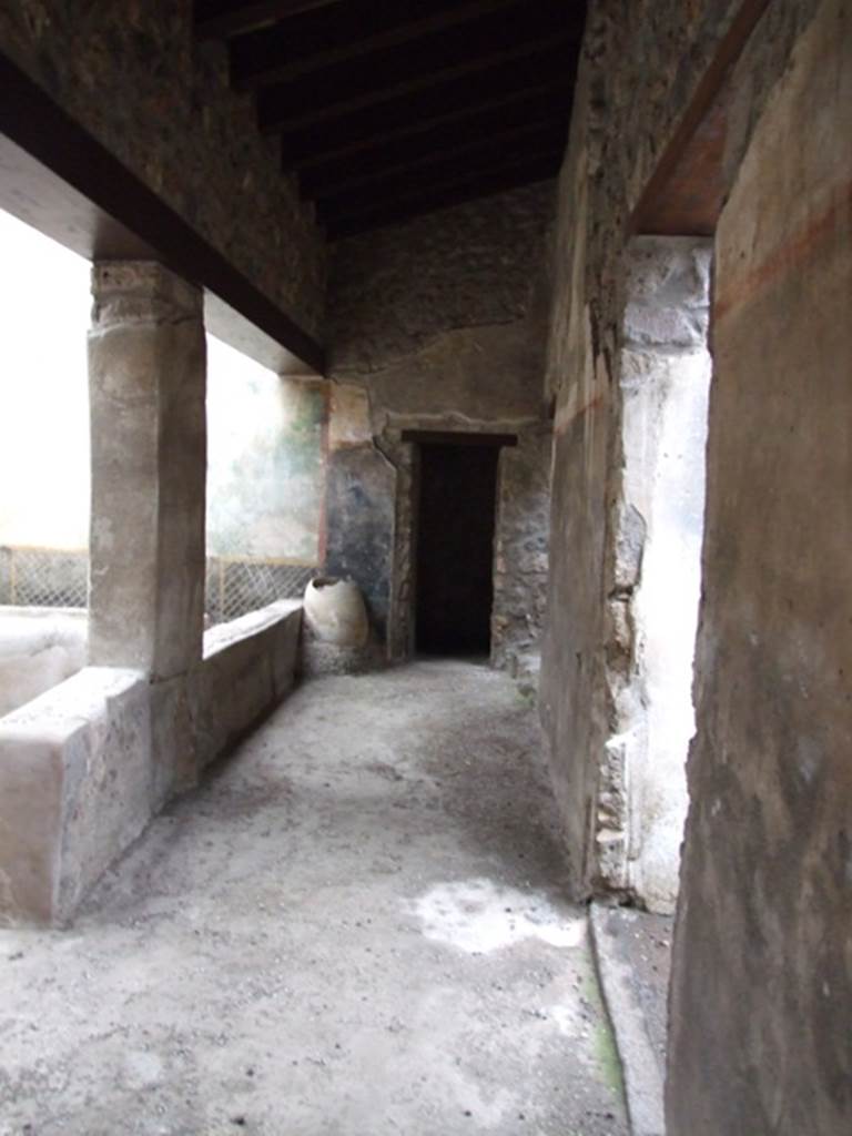 I.11.16 Pompeii. December 2007. 
Room 9, looking east along corridor 9 on south side of triclinium, which gave access to rear rooms.  
At the far end is a door leading to a small alcove, room 13, with the doorway to room 10 on its right.
On the extreme right is the doorway to room 8.
According to Packer’s note: 
“Where they have restored lintels, the heights of the doors to these rooms are as follows: between rooms 9 and 10, 1.96m; that between rooms 9 and 13, 1.71m.”
See Packer, J: Inns at Pompeii: a short survey, in Cronache Pompeiane IV-1978 (p.18-24, with note on page 22).
