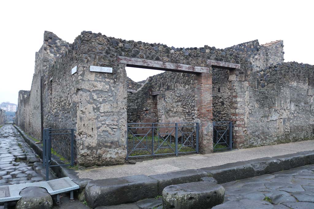I.13.4 Pompeii, on right, with I.13.5, on left. December 2018, 
Entrance doorways on south side of Via dell’Abbondanza, at junction with Via di Nocera. Photo courtesy of Aude Durand.

